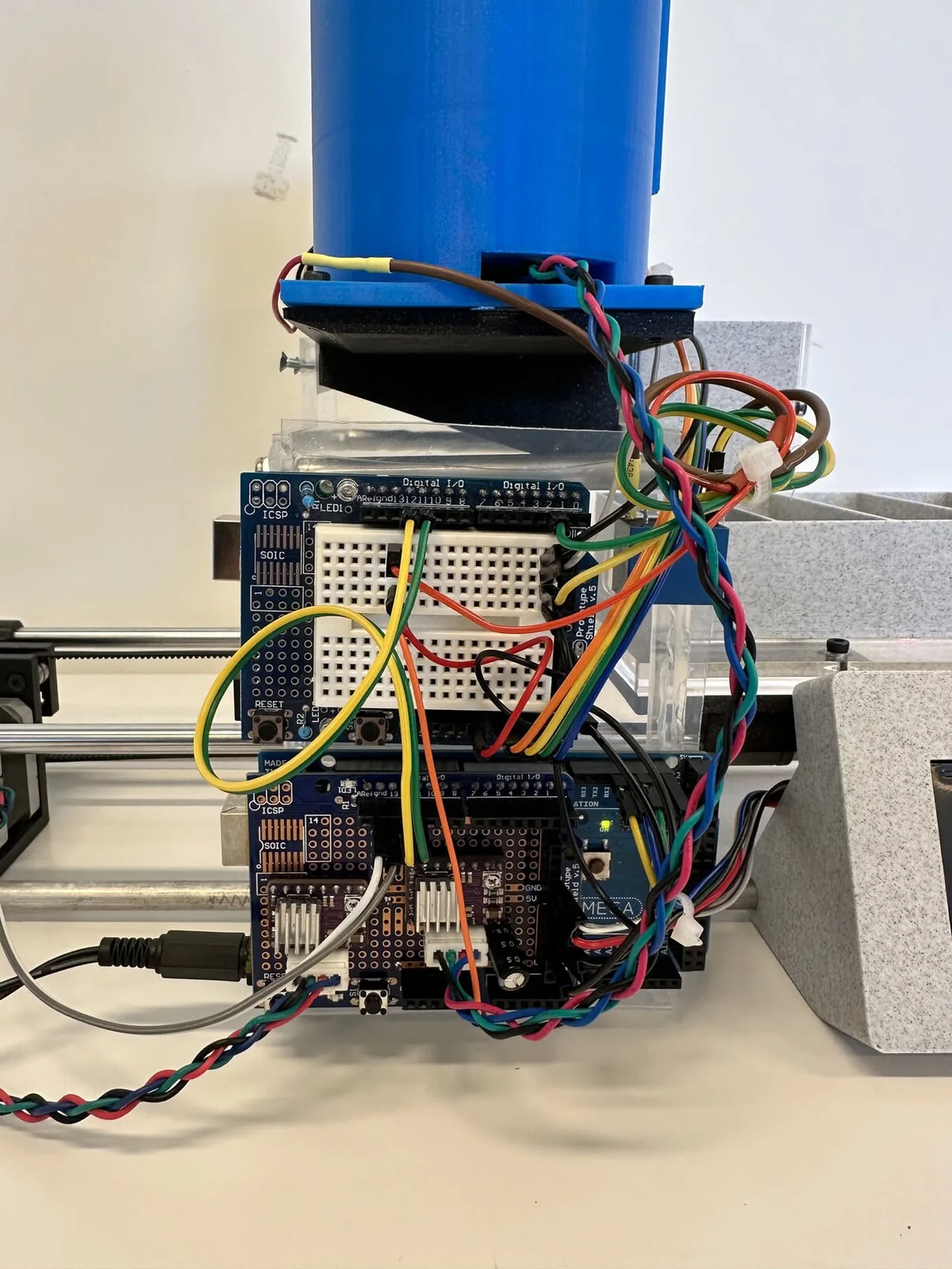 An Arduino Mega with two prototype shields, two stepper drivers and colorful wiring