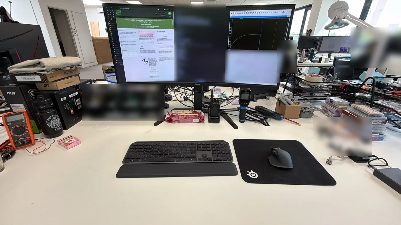 My desk at Tornyol: a curved monitor with ESC Configurator and an LTspice simulation, a multimeter and a thermal camera