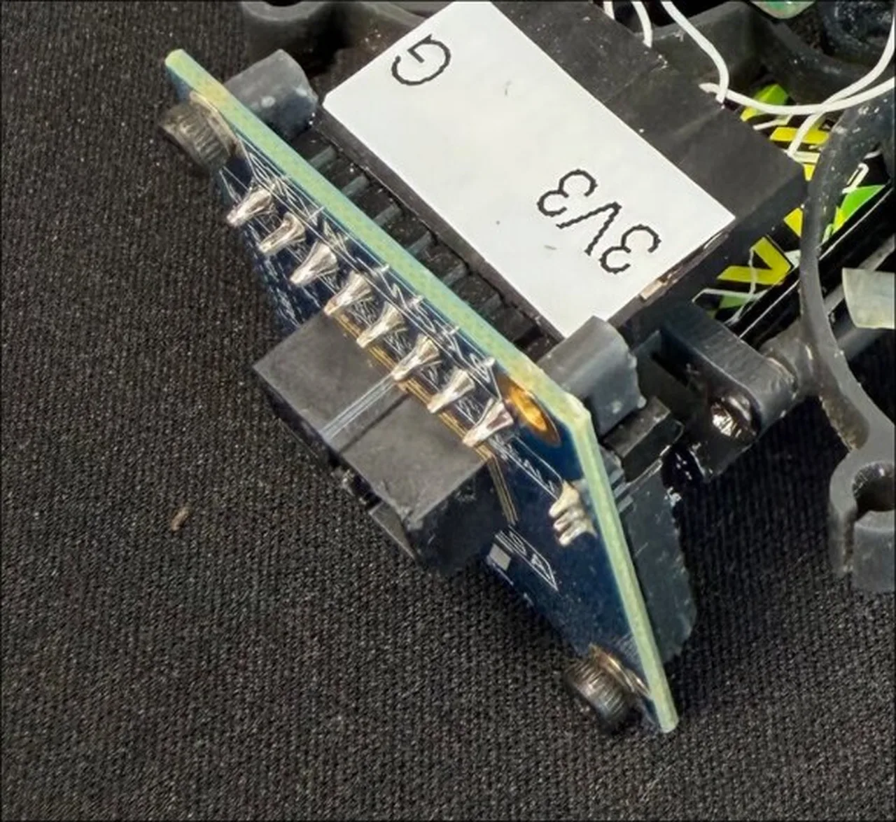 A VL53L9 time-of-flight breakout board mounted on a drone frame, with 3V3 and G labels on the wiring